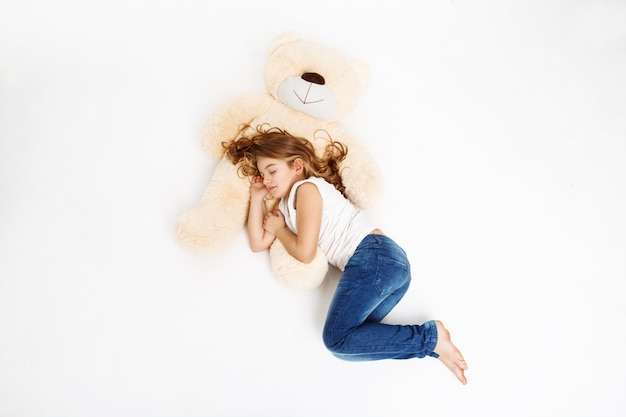 Free photo top view of cute kid sleeping on favourite toy.