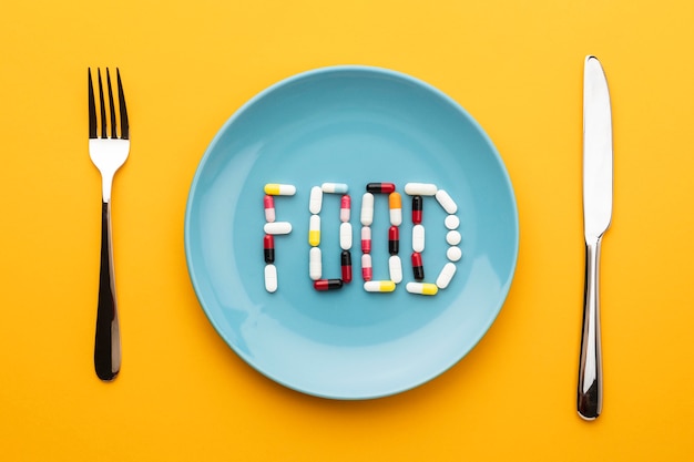 Top view cutlery and food pills