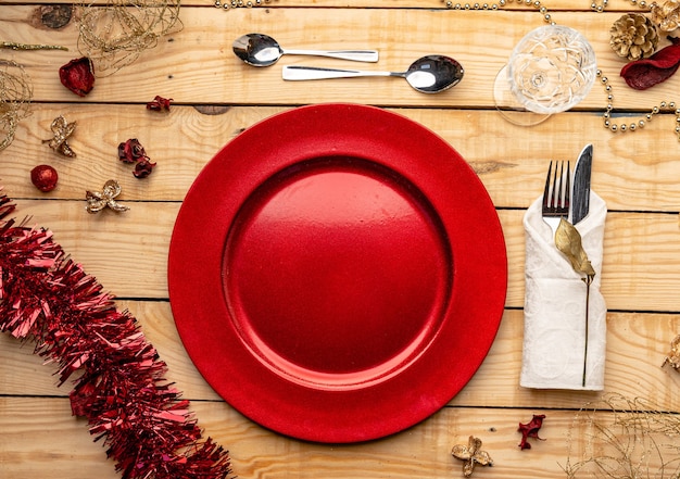 Top view of cutlery and plates on festive wooden background