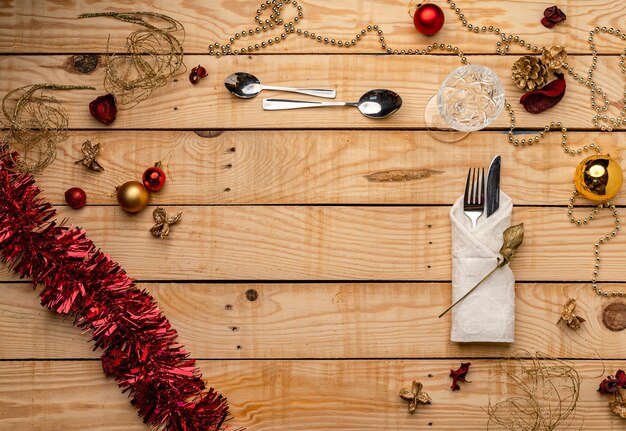 Top view of cutlery on a wooden Christmas background