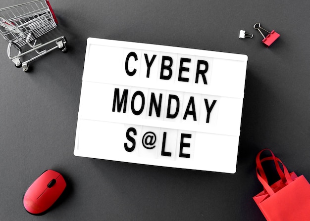 Top view of cyber monday light box with mouse and bags