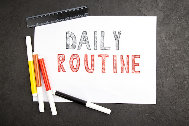 Top view daily routine writing on blank with pencils on a dark surface note photo notepad color copybook