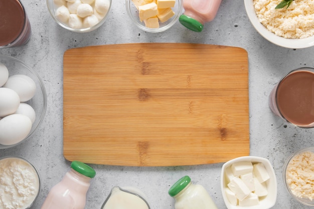 Top view dairy products with wooden board