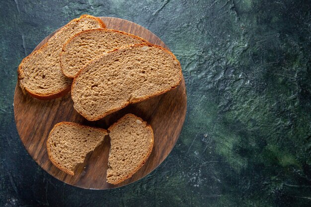 Top view dark bread loafs on dark desk