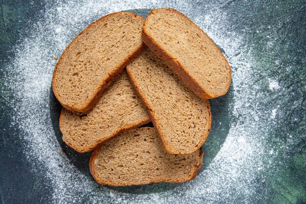 Top view dark bread loafs on dark desk