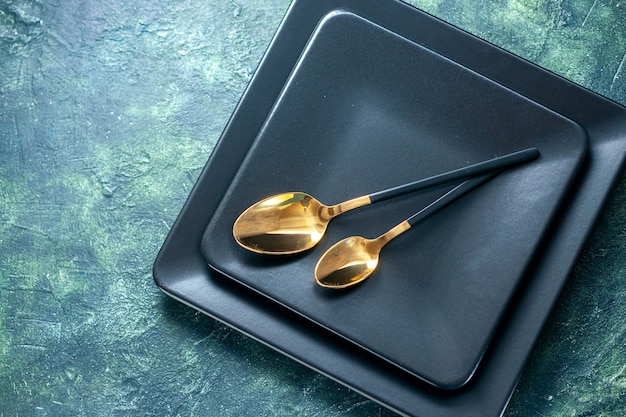 top view dark square plates with golden spoons on dark surface cutlery restaurant lunch color plate tea drink
