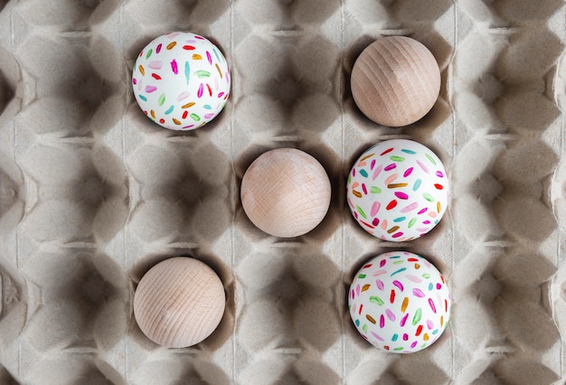 Top view of decorated easter eggs in carton