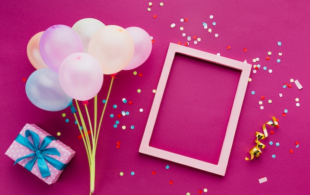 Free photo top view decoration with balloons and frame