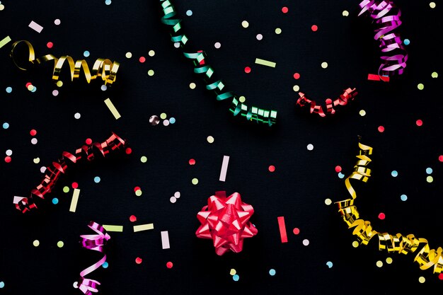 Top view decoration with confetti and black background