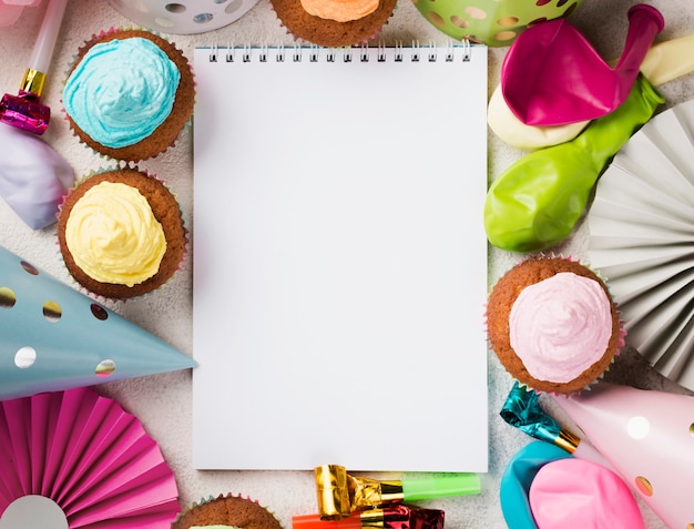 Top view decoration with notebook and muffins