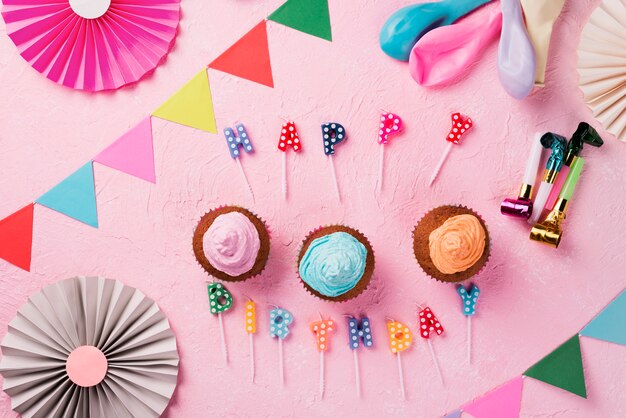 Top view decoration with party decorations and pink background