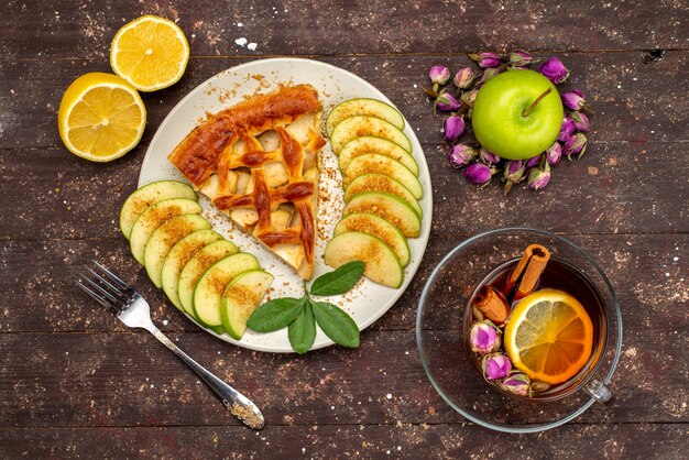 A top view delicious apple cake with tea fresh green apples on the wooden desk cake biscuit sugar  dessert