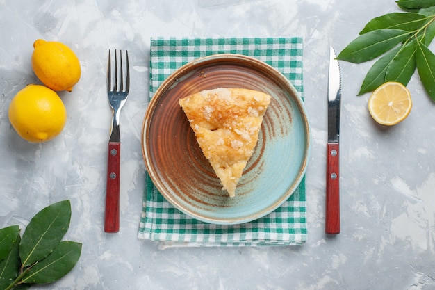 Top view delicious apple pie sliced inside plate with lemon on white desk pie cake sweet sugar bake biscuit