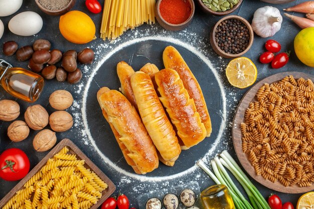 Top view delicious bagels with nuts eggs pasta and seasonings on a dark background walnut meal pepper fruit photo color food