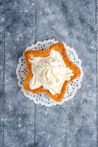 Top view of delicious baked cake star shaped with white yummy cream inside on light desk, cake bake sugar sweet cream