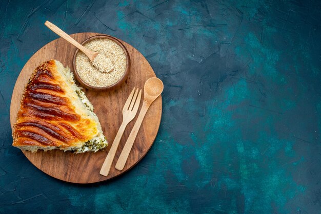 Top view delicious baked pastry sliced with greens inside on the dark desk.