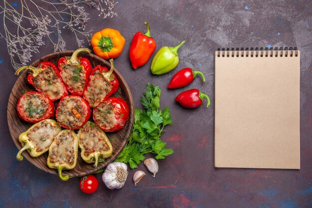 Top view delicious bell-peppers baked dish with mincemeat and vegetables on a dark background dinner food bake salt dish meat