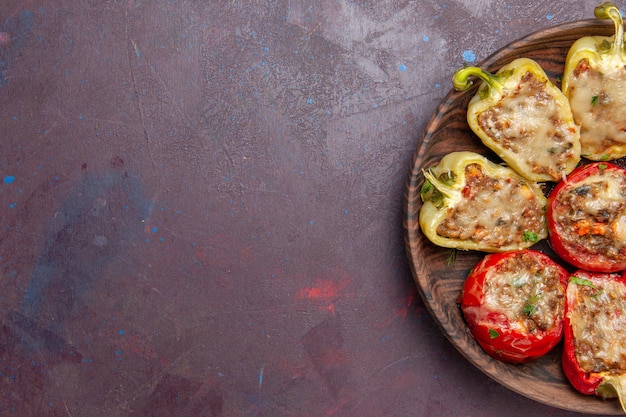 Top view delicious bell-peppers tasty cooked dish with meat on dark background dinner dish meat bake salt