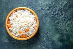 Free photo top view delicious boiled rice inside little plate on dark desk