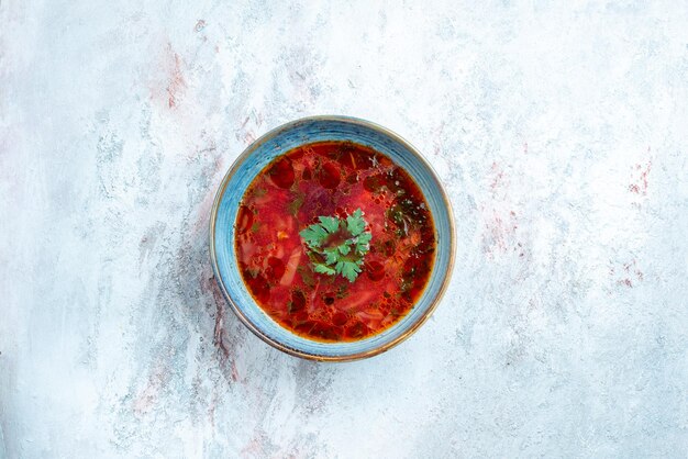 Top view delicious borsch famous ukranian beet soup with meat inside plate on a white space