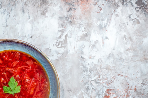 Top view delicious borsch ukrainian beet soup inside plate on the white background