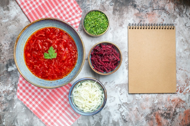 Top view delicious borsch ukrainian beet soup inside plate on the white background