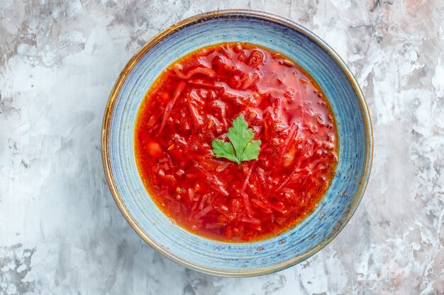 Top view delicious borsch ukrainian beet soup inside plate on white background