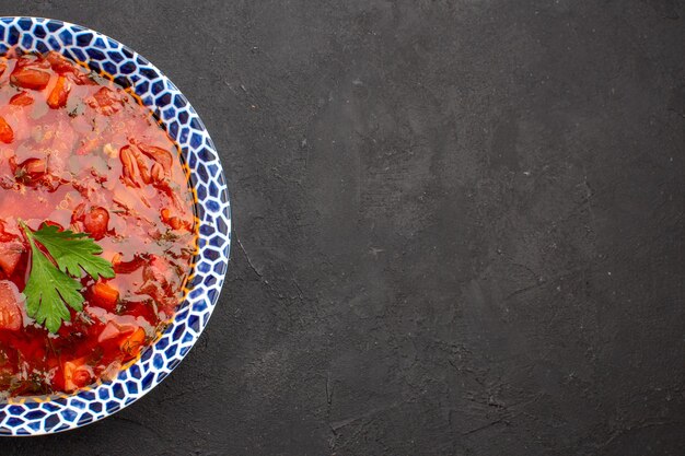 Top view delicious borsch ukranian beet soup on dark space