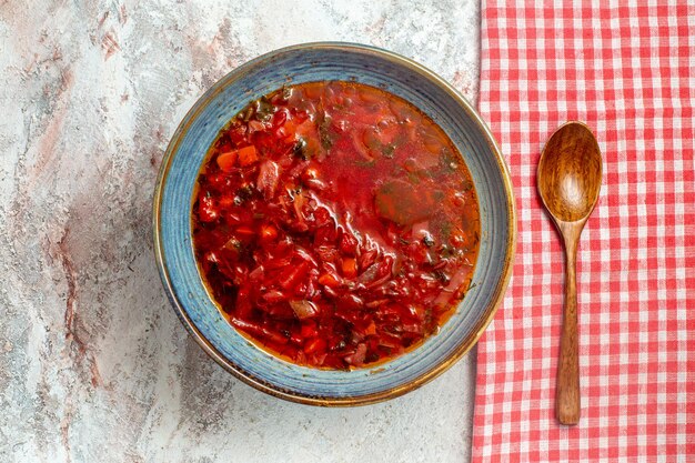 Top view delicious borsch ukranian beet soup on white desk