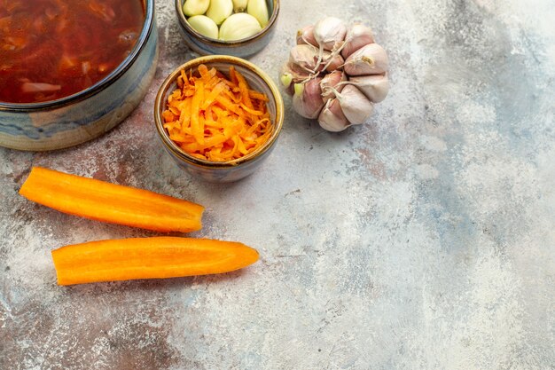 Top view of delicious borscht soup and its ingredients in uncut form on a colorful table