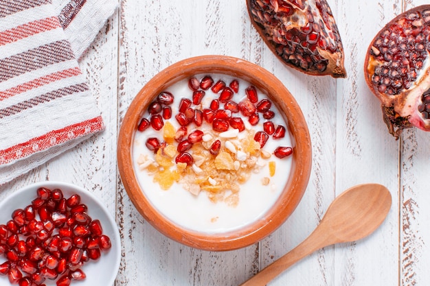 Top view delicious bowl with milk and pomegranate seeds