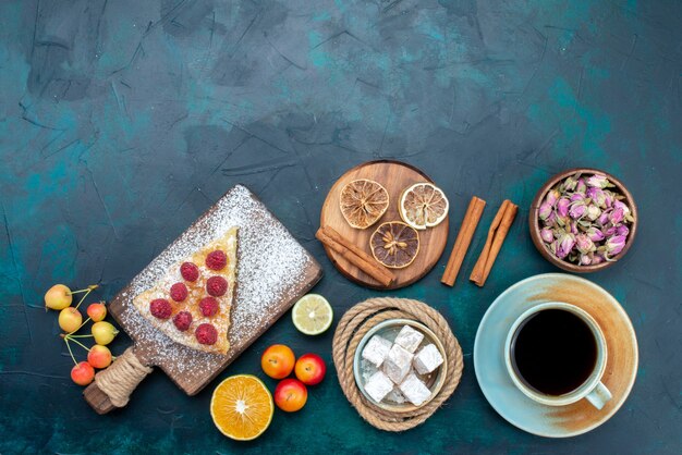 Top view delicious cake slice with tea cinnamon and fruits on the dark-blue desk pie cake sweet biscuit sugar