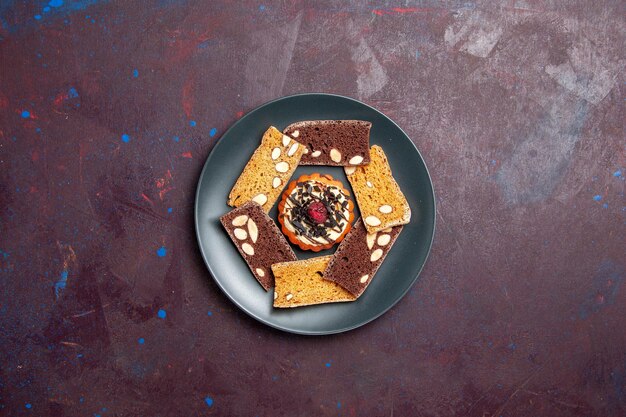 견과류와 어두운 배경 비스킷 쿠키 달콤한 디저트 케이크에 작은 비스킷 상위 뷰 맛있는 케이크 조각