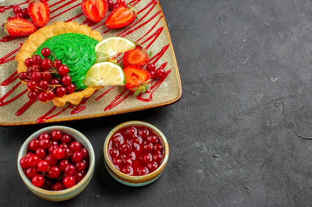 Top view delicious cake with candies and fruits