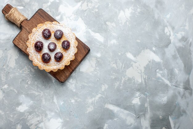 top view of delicious cake with cherries on light desk, cake sweet sugar bake biscuit