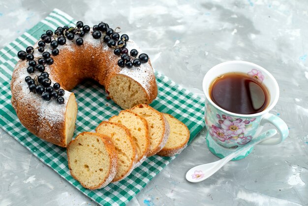 A top view delicious cake with fresh blueberries and tea on the white desk cake biscuit tea berry sugar