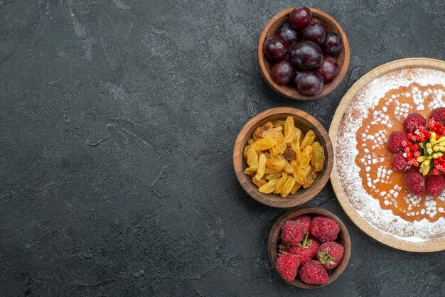 Top view delicious cake with raspberries and fruits on grey background sweet cake pie fruit berry cookie