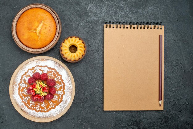 Top view delicious cake with sugar powder and raspberries on a grey background cake pie fruit berry sweet cookie