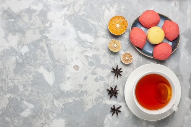 Top view delicious cakes with cup of tea on white background cake pie biscuit sweet sugar tea bake