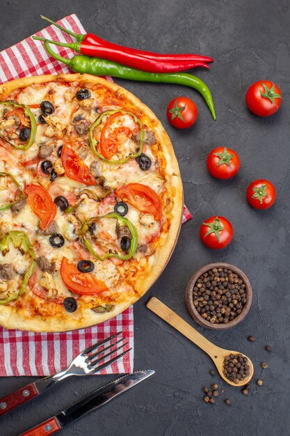 Top view delicious cheese pizza with olives pepper and tomatoes on dark surface