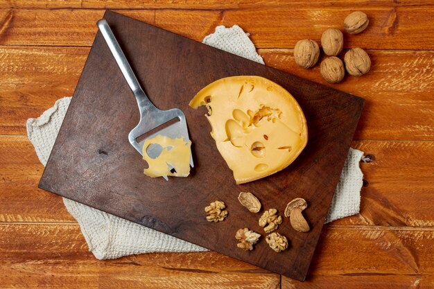 Top view delicious cheese on a wooden board