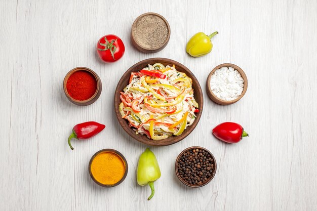 Vista dall'alto deliziosa insalata di pollo con diversi condimenti su uno spuntino da scrivania bianco chiaro insalata fresca di carne pasto maturo