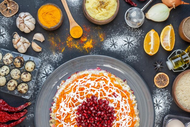 Top view delicious chicken salad with pomegranates and different ingredients on dark background color photo salad snack holiday new year