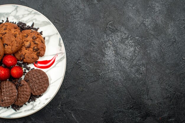 Top view delicious choco biscuits for tea inside plate