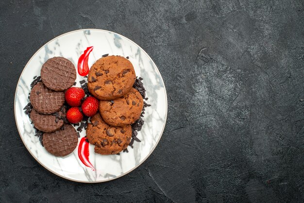 Top view delicious choco biscuits for tea inside plate