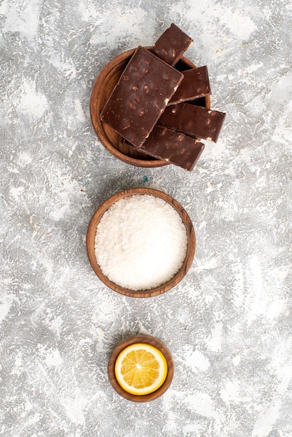 Top view of delicious chocolate bars on a white surface