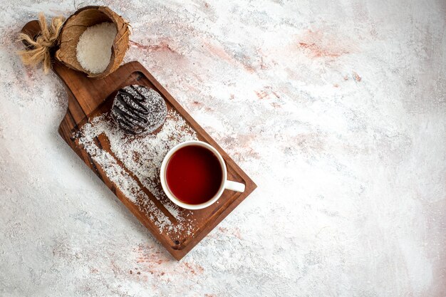 Top view delicious chocolate cake with cup of tea on the white background chocolate cake biscuit sugar sweet cookie tea