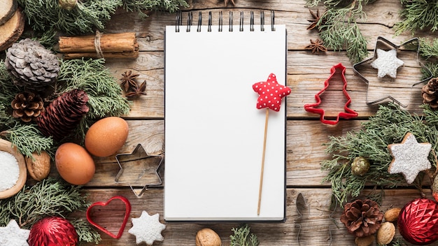 Top view delicious christmas goodies with empty notepad