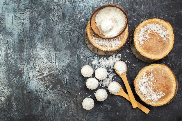 Top view delicious coconut candies on dark background sweet tea fruit color goodie cake yummy