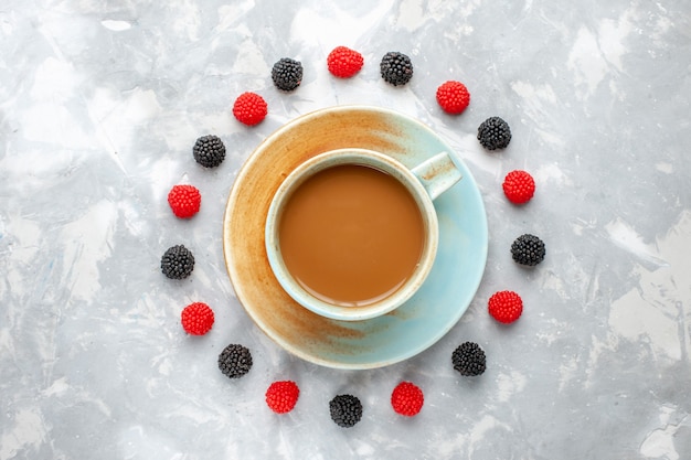 Top view of delicious coffee with circle lined berries on light desk, berry coffee drink espresso